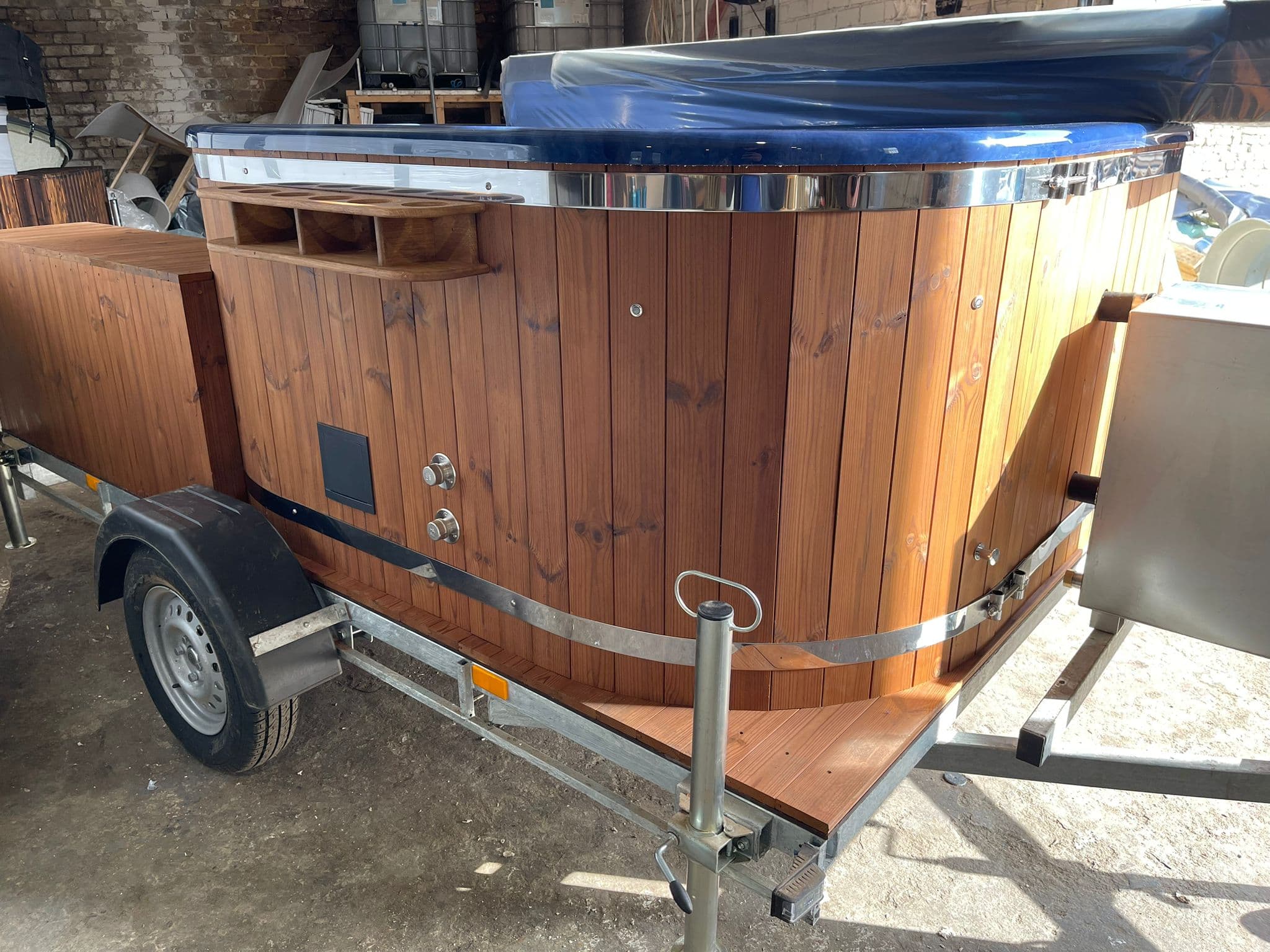 Blue mobile hot tub on trailer — exterior view